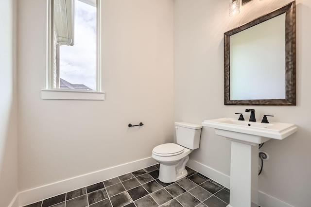 4405 Tower Bluff Rd, Midlothian, TX 76065 - bathroom featuring baseboards, toilet, plenty of natural light, and tile patterned floors