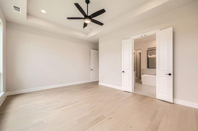 4405 Tower Bluff Rd, Midlothian, TX 76065 - unfurnished bedroom with a raised ceiling, light wood-style floors, baseboards, ensuite bath, and recessed lighting