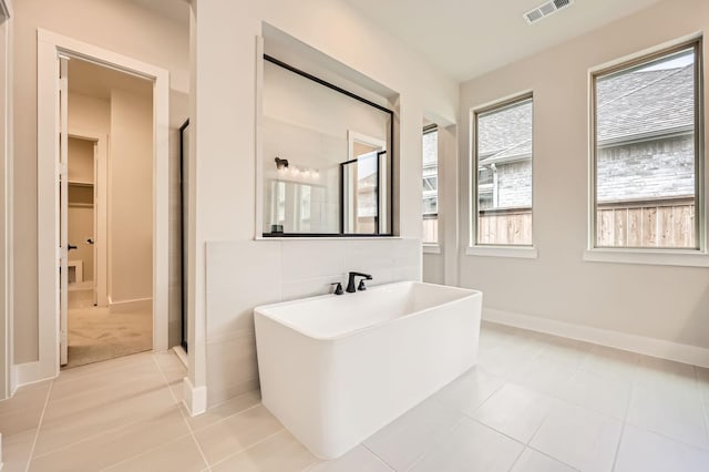 4405 Tower Bluff Rd, Midlothian, TX 76065 - bathroom featuring a shower stall, tile patterned flooring, baseboards, and a freestanding bath