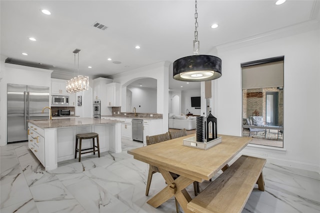 dining space featuring crown molding and sink