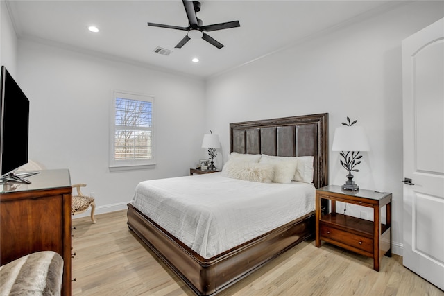 bedroom featuring ornamental molding, ceiling fan, and light hardwood / wood-style flooring