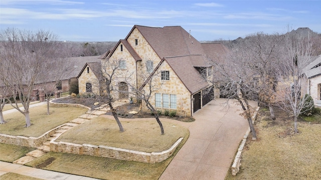 english style home featuring a front yard