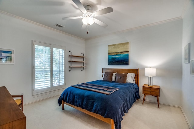 carpeted bedroom featuring crown molding and ceiling fan