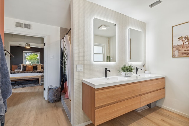 9704 Lanward Dr, Dallas, TX 75238 - bathroom with backsplash, wood-type flooring, vanity, and a wealth of natural light