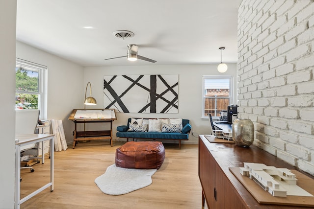 9704 Lanward Dr, Dallas, TX 75238 - sitting room with ceiling fan, brick wall, a healthy amount of sunlight, and light wood-type flooring