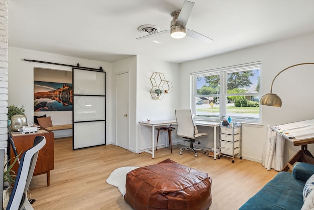 9704 Lanward Dr, Dallas, TX 75238 - home office featuring ceiling fan, a barn door, and light hardwood / wood-style floors