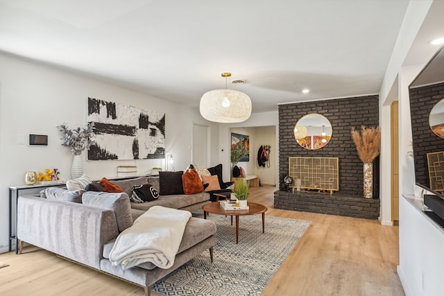 9704 Lanward Dr, Dallas, TX 75238 - living room featuring a brick fireplace and light wood-type flooring