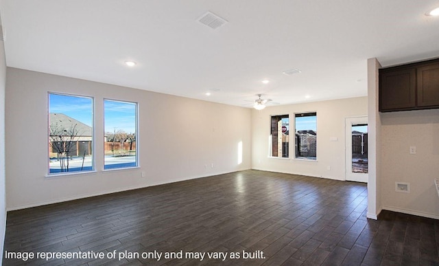 unfurnished living room with dark hardwood / wood-style flooring and ceiling fan