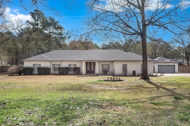 ranch-style home with a garage and a front yard