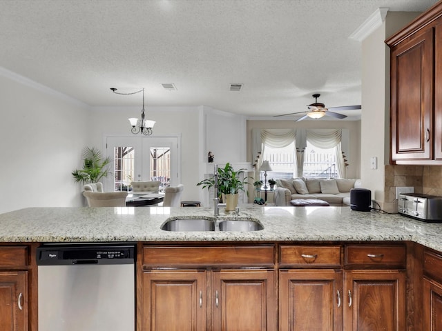 kitchen featuring light stone counters, a sink, visible vents, stainless steel dishwasher, and crown molding