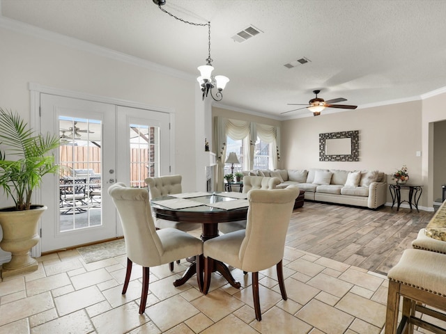 dining space featuring french doors, visible vents, crown molding, and a textured ceiling