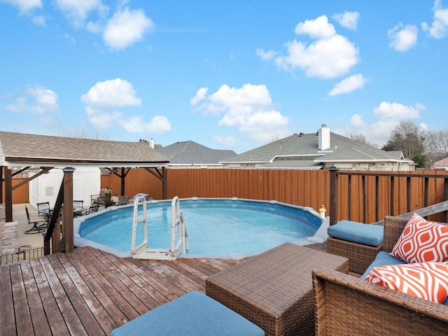 view of pool featuring a fenced in pool, fence, a deck, and a patio