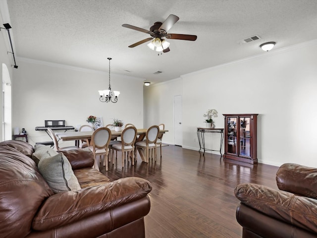 living room with a textured ceiling, visible vents, dark wood-style flooring, and ornamental molding