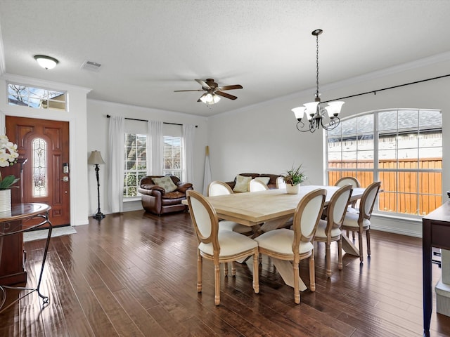 dining room with visible vents, dark wood finished floors, and crown molding