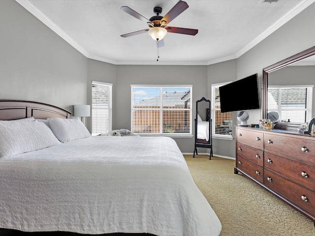 bedroom with crown molding, baseboards, a ceiling fan, and light colored carpet