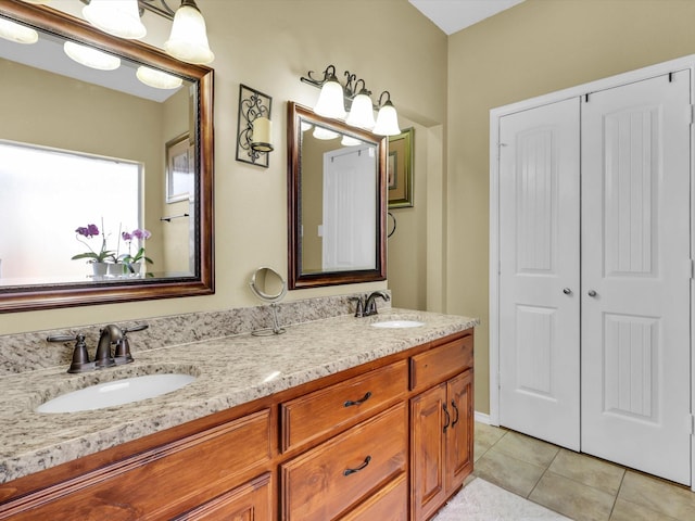 full bath featuring double vanity, a sink, and tile patterned floors