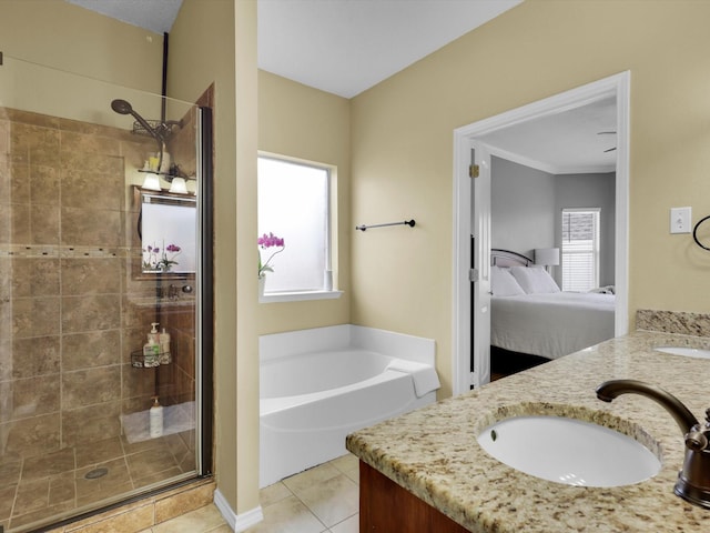 ensuite bathroom with ensuite bathroom, a garden tub, a sink, a shower stall, and tile patterned floors