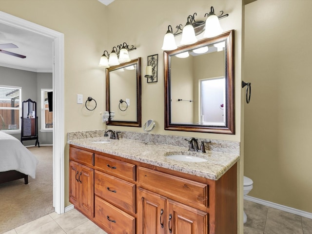 bathroom featuring toilet, tile patterned flooring, a sink, and a ceiling fan