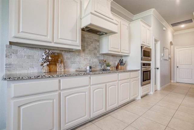 kitchen featuring white cabinetry, light tile patterned floors, custom exhaust hood, and stainless steel appliances