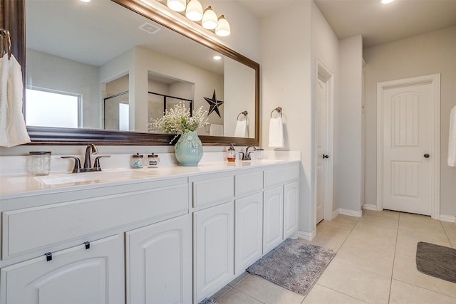 bathroom featuring vanity, tile patterned flooring, and a shower