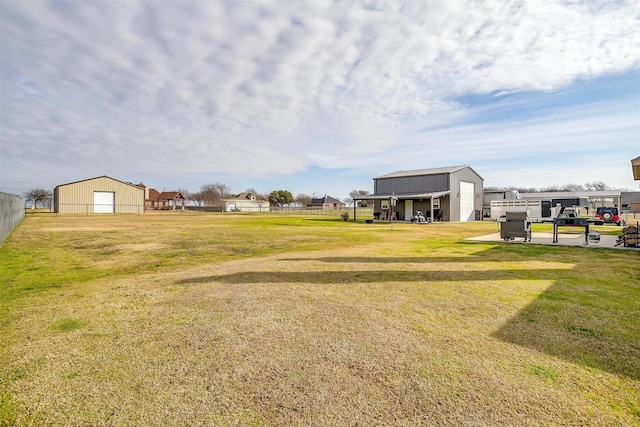 view of yard featuring a garage and an outdoor structure