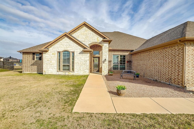 french country style house featuring a front lawn