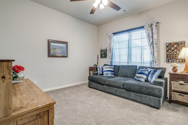 carpeted living room with ceiling fan