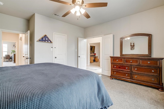 bedroom featuring light colored carpet and ceiling fan