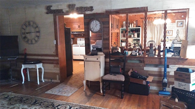 interior space featuring wood finished floors, white electric range, and under cabinet range hood