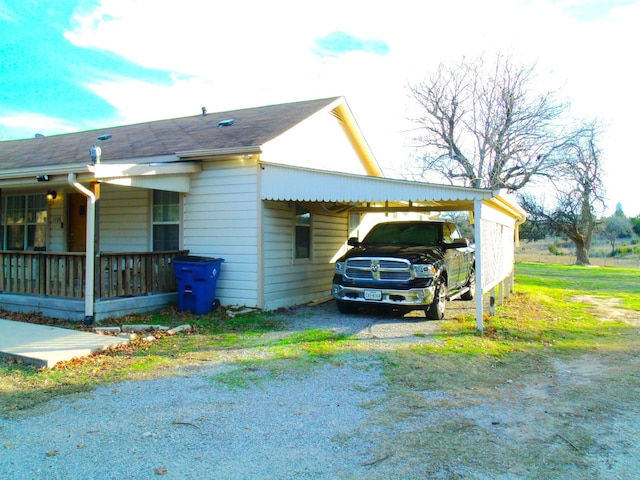 view of side of home featuring a carport and driveway