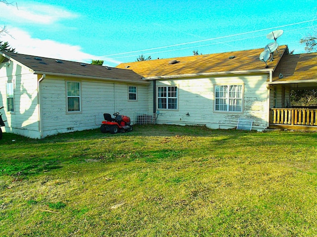 rear view of property with a yard