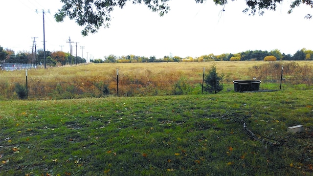 view of yard with a rural view and fence