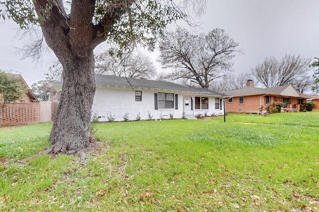 ranch-style home featuring a front yard