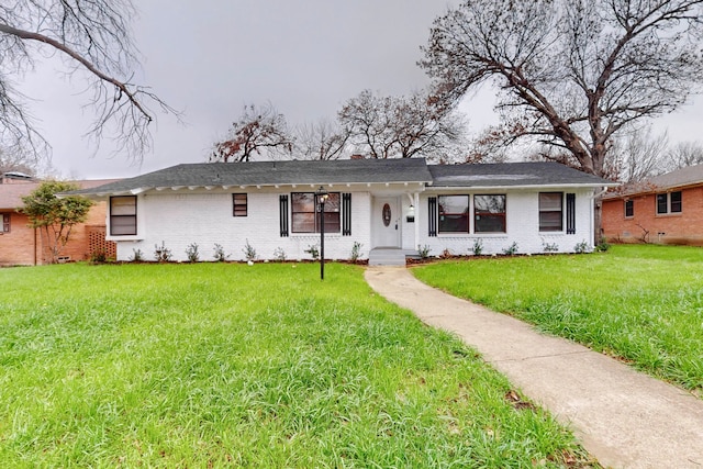 ranch-style home featuring a front yard