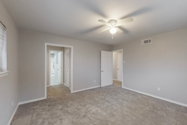 unfurnished bedroom featuring light colored carpet and ceiling fan