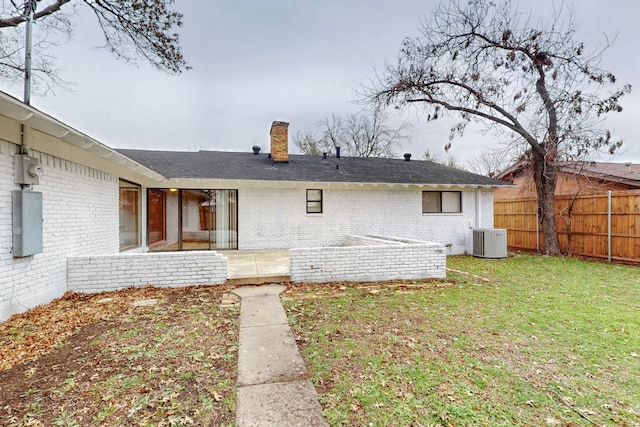 back of house featuring cooling unit and a yard