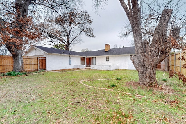 back of property featuring a yard