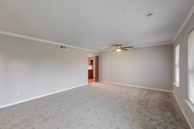 unfurnished room with crown molding, carpet, and ceiling fan