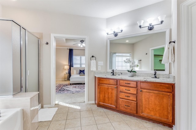 bathroom featuring tile patterned floors, vanity, plus walk in shower, and plenty of natural light