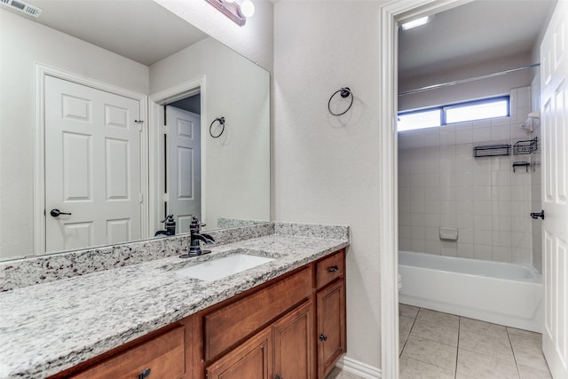 full bathroom with tile patterned floors, toilet, vanity, and tiled shower / bath combo