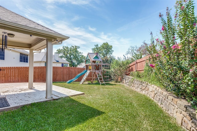 view of playground with a patio area and a lawn