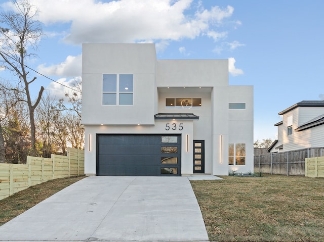 modern home with a garage and a front lawn