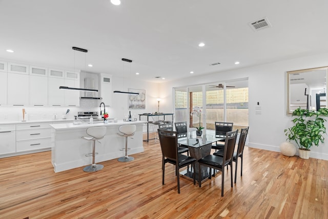 dining area featuring ceiling fan and light hardwood / wood-style floors