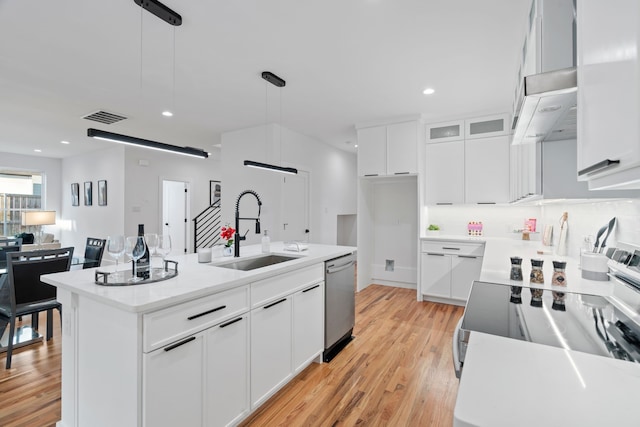 kitchen featuring white cabinetry, an island with sink, sink, and pendant lighting