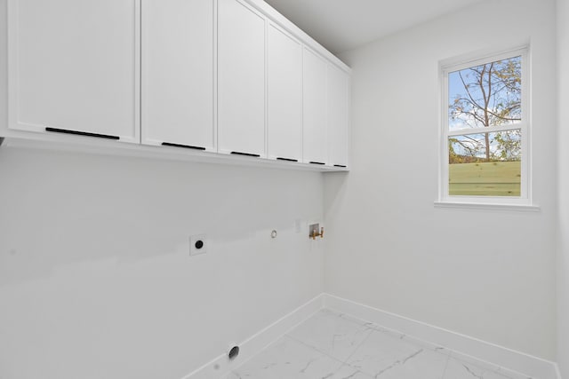 clothes washing area featuring gas dryer hookup, hookup for a washing machine, cabinets, and hookup for an electric dryer