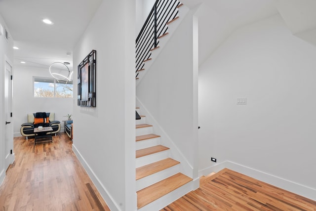 stairway with hardwood / wood-style flooring