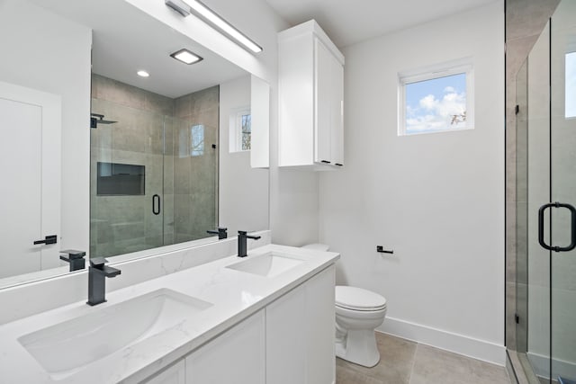 bathroom featuring a shower with door, vanity, tile patterned floors, and toilet