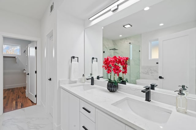 bathroom featuring plenty of natural light, separate shower and tub, and vanity