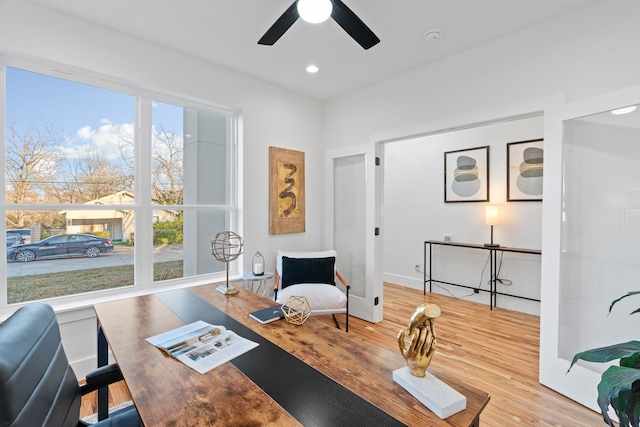 office with hardwood / wood-style floors and ceiling fan