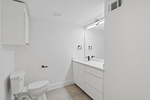 bathroom featuring vanity, tile patterned floors, and toilet